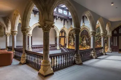 an ornate room with columns and a staircase in a building at The Arthur Suite Stone Cross Mansion in Ulverston