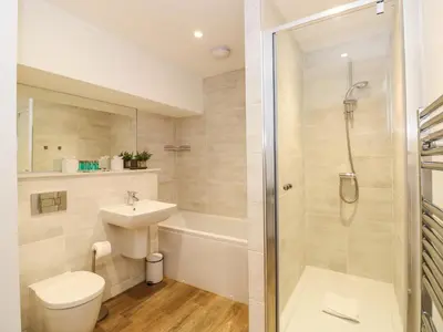 a bathroom with a shower toilet and a sink at The Arthur Suite Stone Cross Mansion in Ulverston