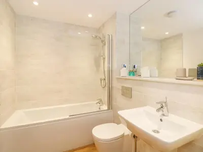 a bathroom with a sink and a tub and a toilet at The Elizabeth Suite Stone Cross Mansion in Ulverston