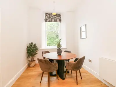 a dining room with a table and chairs at The Elizabeth Suite Stone Cross Mansion in Ulverston