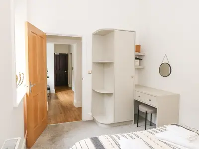 a white bedroom with a desk and a bed at The Elizabeth Suite Stone Cross Mansion in Ulverston