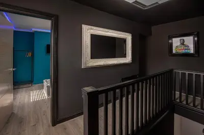 a room with a staircase and a mirror on a wall at Town View Apartment by Sasco in Blackpool