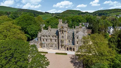 an old castle in the middle of a forest at The Myles Suite Stone Cross Mansion in Ulverston