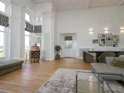 a living room with a couch and a table at The Myles Suite Stone Cross Mansion in Ulverston
