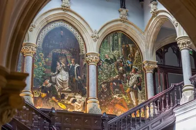 a large painting on the wall of a building with stairs at The Theobold Suite Stone Cross Mansion in Ulverston
