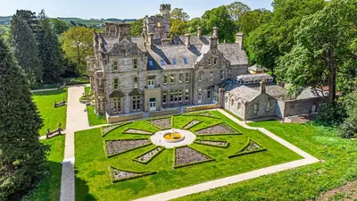 an aerial view of an old castle with a garden at The Theobold Suite Stone Cross Mansion in Ulverston
