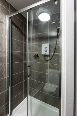 a shower with a glass door in a bathroom at The Anfield Inn in Liverpool