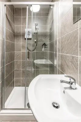 a bathroom with a sink and a shower at The Anfield Inn in Liverpool