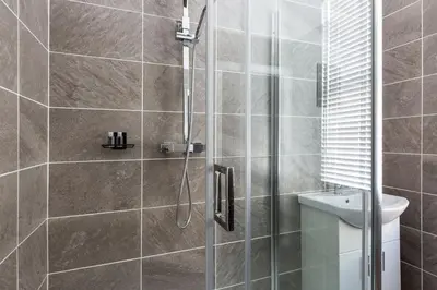 a bathroom with a shower and a toilet at The Anfield Inn in Liverpool