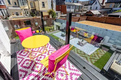 a balcony with a table and chairs on a patio at Empress Hall Blackpool by Charles Alexander Short Stay - Sleeps 20 in Blackpool