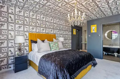 a bedroom with a large bed and a chandelier at Empress Hall Blackpool by Charles Alexander Short Stay - Sleeps 20 in Blackpool