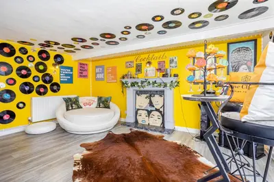 a yellow room with a toilet and a fireplace at Empress Hall Blackpool by Charles Alexander Short Stay - Sleeps 20 in Blackpool