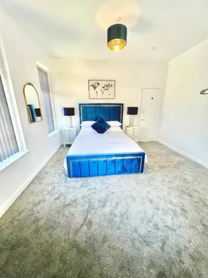 a bedroom with a blue bed in a room at Winter Gardens Presidential Suite Blackpool in Blackpool