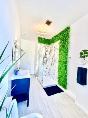 a bathroom with a green ivy wall at Winter Gardens Presidential Suite Blackpool in Blackpool