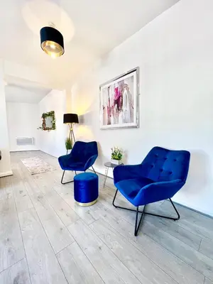 two blue chairs and a table in a room at Winter Gardens Presidential Suite Blackpool in Blackpool