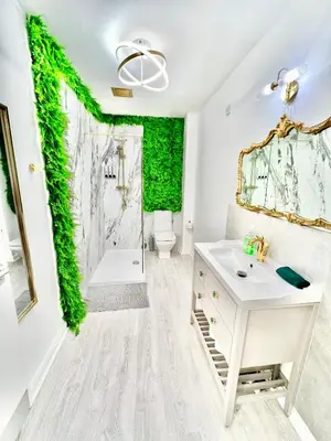 a bathroom with a green wall at Winter Gardens Owners Suite Blackpool in Blackpool