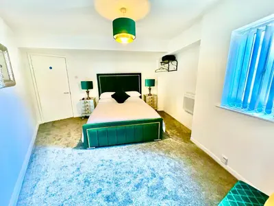 a bedroom with a bed and a blue rug at Winter Gardens Owners Suite Blackpool in Blackpool