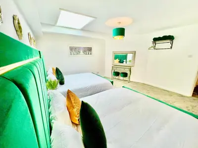 a bedroom with two beds and a skylight at Winter Gardens Owners Suite Blackpool in Blackpool