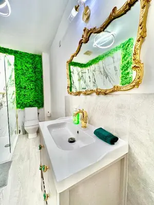 a bathroom with a sink and a mirror at Winter Gardens Owners Suite Blackpool in Blackpool