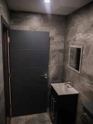 a bathroom with a black door and a sink at New Oxford House Apartments By Happy Days in Liverpool