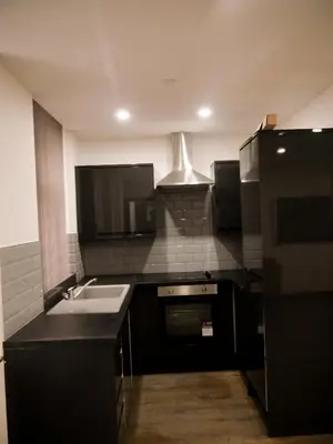 a kitchen with a sink and a stove at New Oxford House Apartments By Happy Days in Liverpool