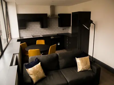 a living room with a couch and a table at New Oxford House Apartments By Happy Days in Liverpool
