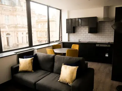 a living room with a couch and a table at New Oxford House Apartments By Happy Days in Liverpool