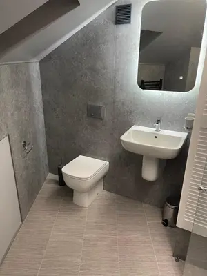 a bathroom with a toilet and a sink at The Welcome Apartment in Blackpool