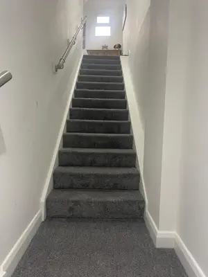 a stairway with a stair case in a building at The Welcome Apartment in Blackpool