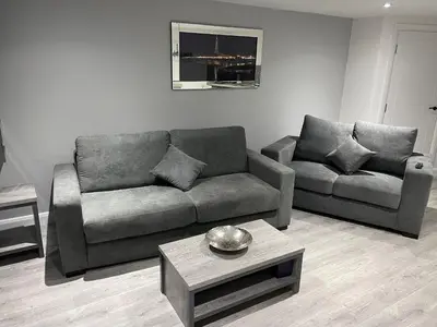 a living room with a couch and a table at The Welcome Apartment in Blackpool