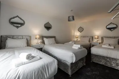 two beds in a room with two twin beds at RST Cumberland Street in Liverpool