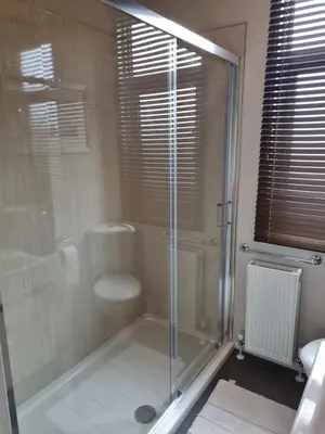 a bathroom with a glass shower with a toilet at Pemberton Arrondale Lodge, Lakeside View (Haven Lakeland) in Flookburgh