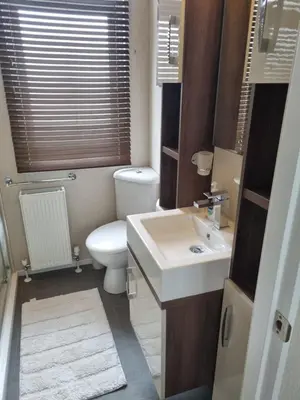 a small bathroom with a toilet and a sink at Pemberton Arrondale Lodge, Lakeside View (Haven Lakeland) in Flookburgh