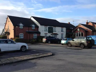 a group of cars parked in a parking lot at The Villa Express in Kirkham
