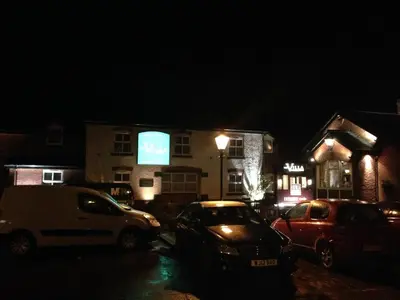 a group of cars parked in a parking lot at night at The Villa Express in Kirkham