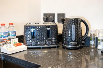 two toasters sitting on a counter next to a toaster at Withnell Stays - Apartment Six in Blackpool