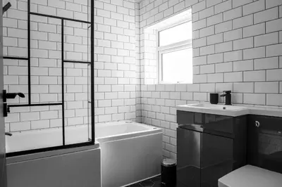 a black and white bathroom with a tub and a sink at Withnell Stays - Apartment Six in Blackpool
