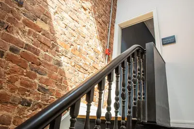 a brick building with a staircase next to a door at Withnell Stays - Apartment Six in Blackpool