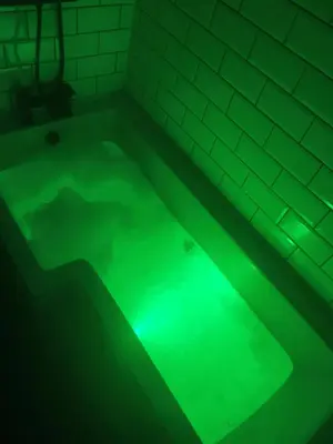 a green bath tub with a green light in it at Withnell Stays - Apartment Five in Blackpool