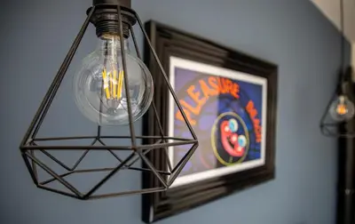 a light hanging from a wall next to a picture at Withnell Stays - Apartment Five in Blackpool