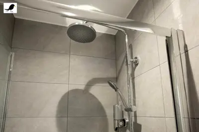 a shower with a glass door with a shower head at Blackbird Accommodation and Luxury Apartments room 11 in Blackpool