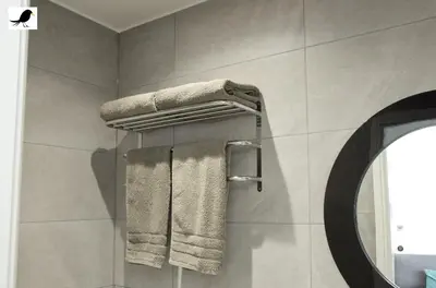 a bathroom with a towel rack and a mirror at Blackbird Accommodation and Luxury Apartments room 11 in Blackpool