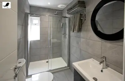 a bathroom with a shower and a toilet and a sink at Blackbird Accommodation and Luxury Apartments room 14 in Blackpool
