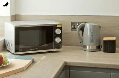 a microwave on a kitchen counter with a plate of fruit at Blackbird Accommodation and Luxury Apartments room 15 in Blackpool