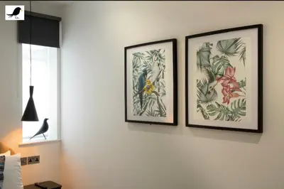 two framed pictures of plants on a wall at Blackbird Accommodation and Luxury Apartments room 15 in Blackpool