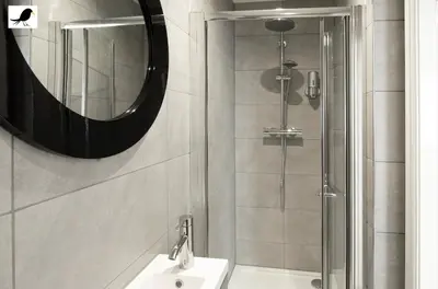a bathroom with a shower and a sink and a mirror at Blackbird Accommodation and Luxury Apartments room 15 in Blackpool