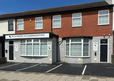 a red brick building with a sign on it at Blackbird Accommodation and Luxury Apartments room 15 in Blackpool