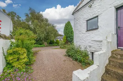 a white building with a window on the side of it at No.1 The Coach House in Silverdale