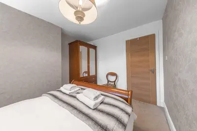 a bedroom with a bed with towels on it at No.1 The Coach House in Silverdale