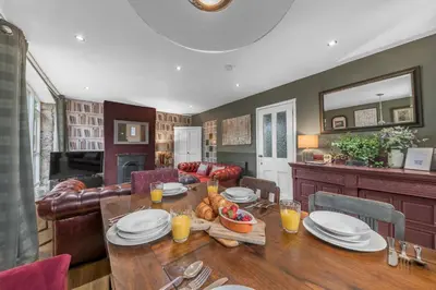 a dining room with a table with food on it at No.1 The Coach House in Silverdale